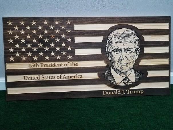 This 29" carved flag has the 45th President of the United States of America's face carved out on it. This flag is extremely detailed and the entire flag, including the stars, are carved into the wood. 