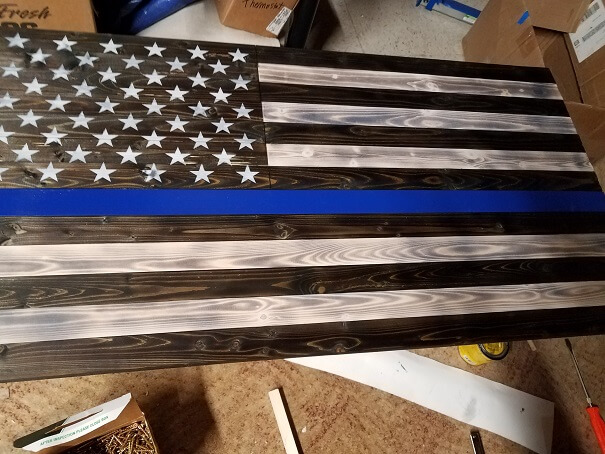 This rustic style police flag is a solute to law enforcement. It is stained and painted by hand with solid wood.  Measures 19.5" x 37". Limited quantity. 