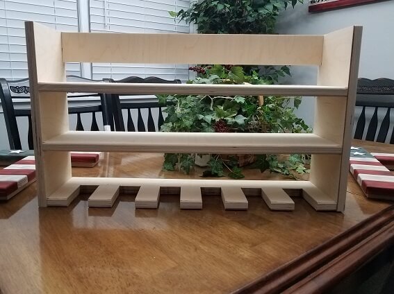 This shelf made of cabinet-grade wood can hold up to 6 cordless drills (and other tools) hanging from the bottom slots. The price is for the shelf pictured above without paint or clearcoat. Message us if you want the shelf to include paint or clearc