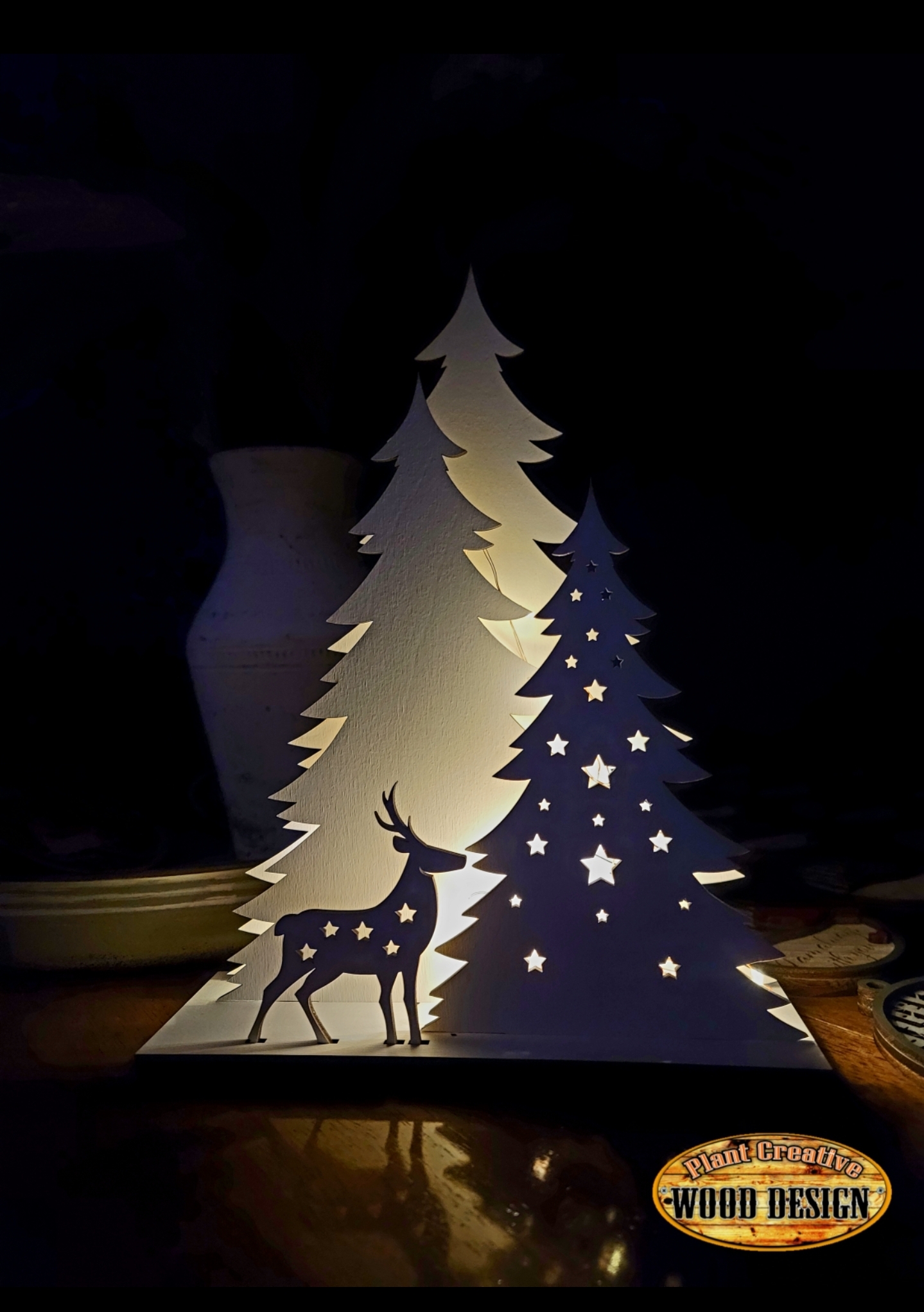 A glowing Forest and Deer Scene that stands ~12" tall. The design allows for the trees and deer to be removed to essentially make it lay flat for easy storage. Comes with lights and a battery. 